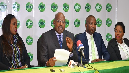 Globacom's Head of Operations, Bisi Koleoso, explaining the workings of the new 3-in-1 Recharge Option at the launch of the service by Globacom on Tuesday in Lagos. With him are Miss Ronke Ali Oke (left), Coordinator Gloworld, Dimeji Amao (second right) and Miss Omolade Odunola, all of Globacom.